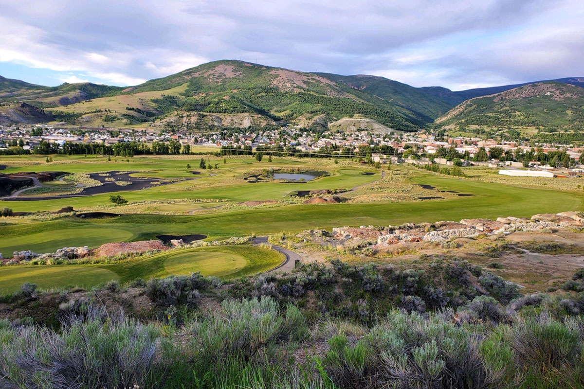 Golf course with mountains in background.